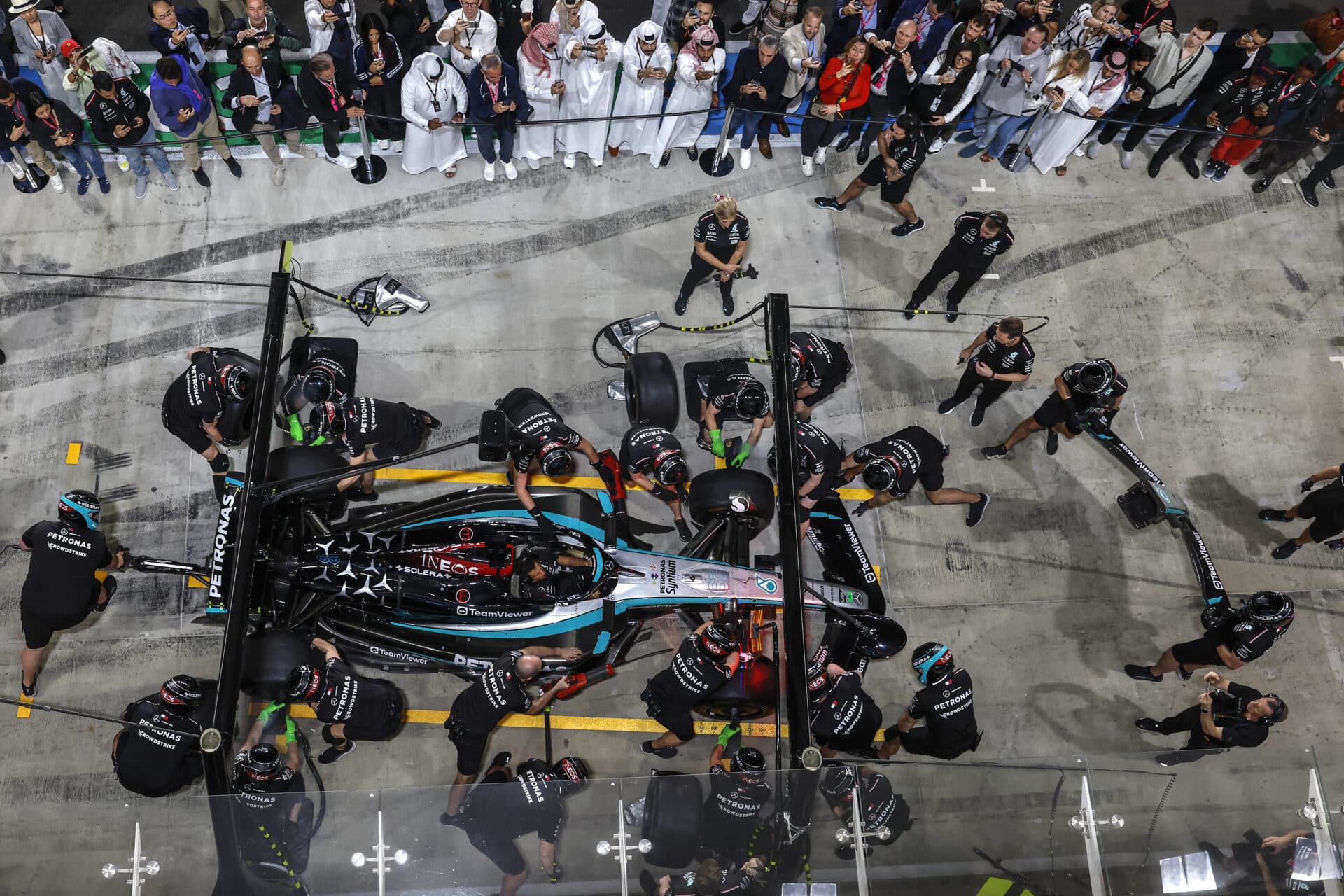 Pit Lane walk guests watch Mercedes-AMG F1 Team pit stop practice